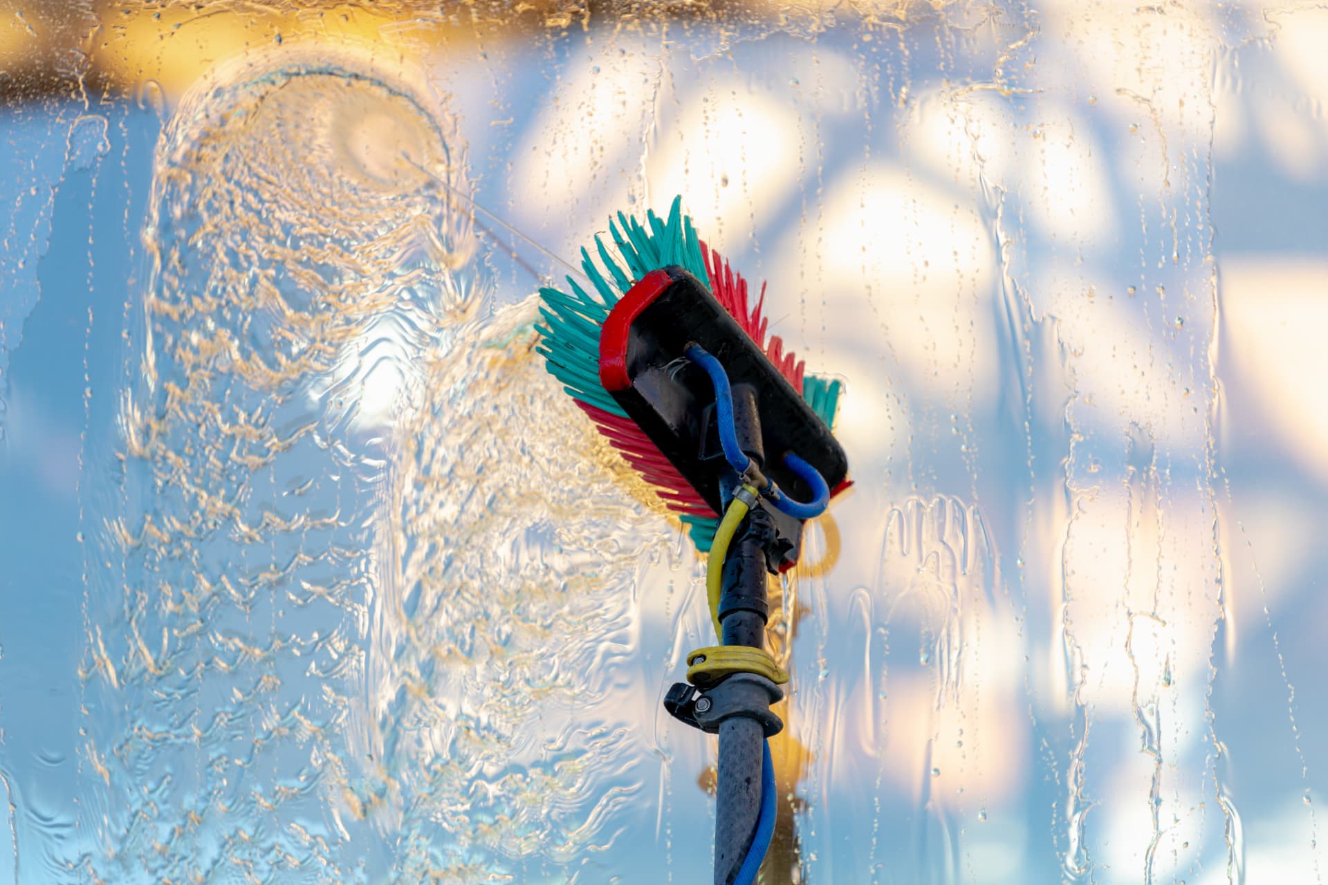 Professional window cleaning brush on wet glass